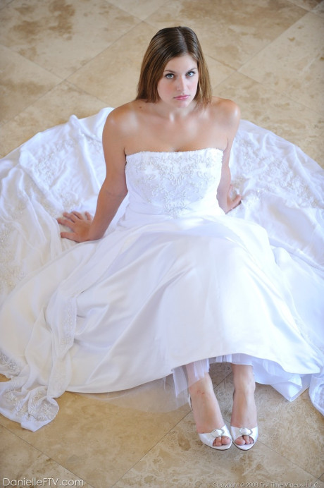 Busty glamorous amateur Danielle models wedding gown indoors & by the pool