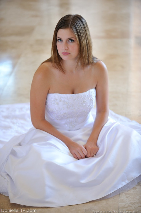 Busty glamorous amateur Danielle models wedding gown indoors & by the pool