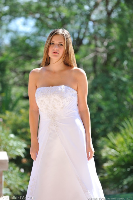 Busty glamorous amateur Danielle models wedding gown indoors & by the pool