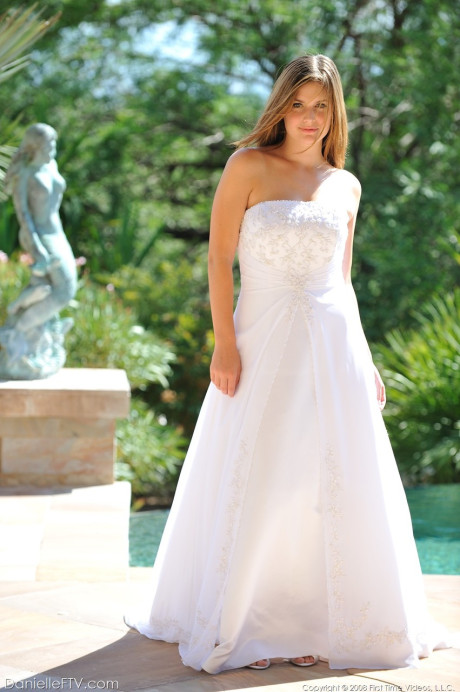 Busty glamorous amateur Danielle models wedding gown indoors & by the pool