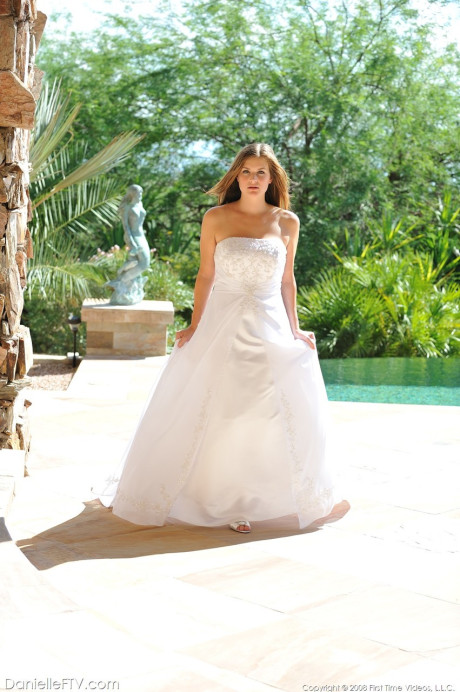 Busty glamorous amateur Danielle models wedding gown indoors & by the pool